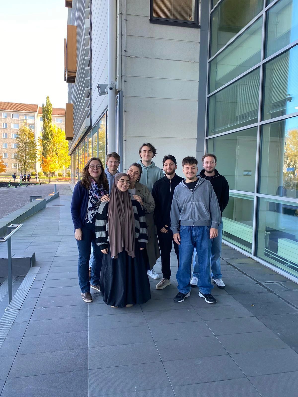 Students gathering outside modern building showcasing diversity in education.