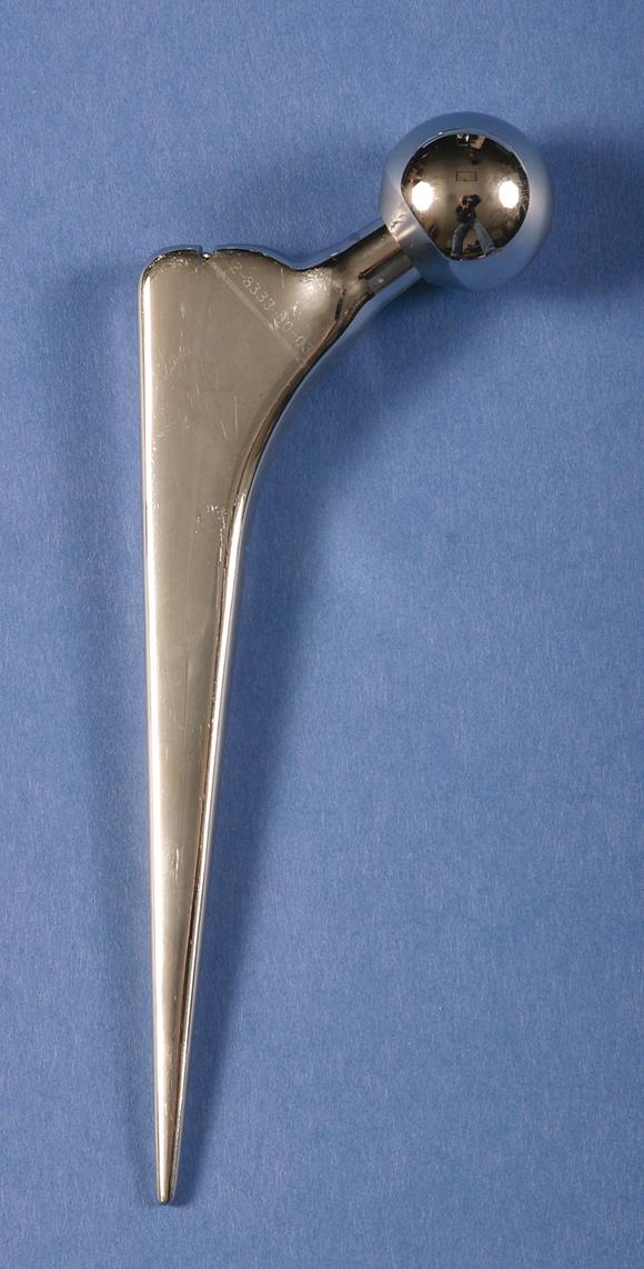 FIGURE 3.18, Collarless, polished, tapered (CPT) hip stem. CPT design allows controlled subsidence and maintains compressive stresses within cement mantle.