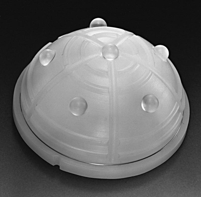 FIGURE 3.30, Acetabular component designed for cement fixation. Textured surface and polymethyl methacrylate spacers optimize cement mantle and cement-prosthesis interface.