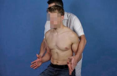 FIG. 19.4, External rotation resistance test: with both arms in neutral position and elbows flexed at 90 degrees, the patient rotates the shoulder externally against the resistance of the examiner.