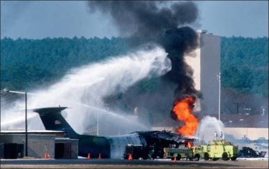 Fig. 5.2, Pope Air Force Base, North Carolina, 1994. Airport fire trucks extinguish a burning aircraft at the scene of the crash. Rescue efforts were aided by combat medics who were preparing to participate in parachute operations.