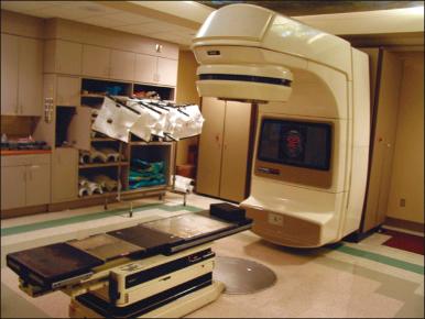 Figure 65.3, Linear accelerator with reference laser lights shown for reproducible patient setup.