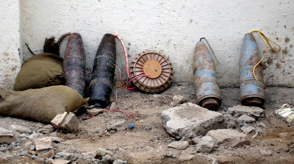 FIGURE 1, Improvised explosive device comprised of four large artillery shells and an antitank mine wired together (or “daisy-chained”) with detonating cord.