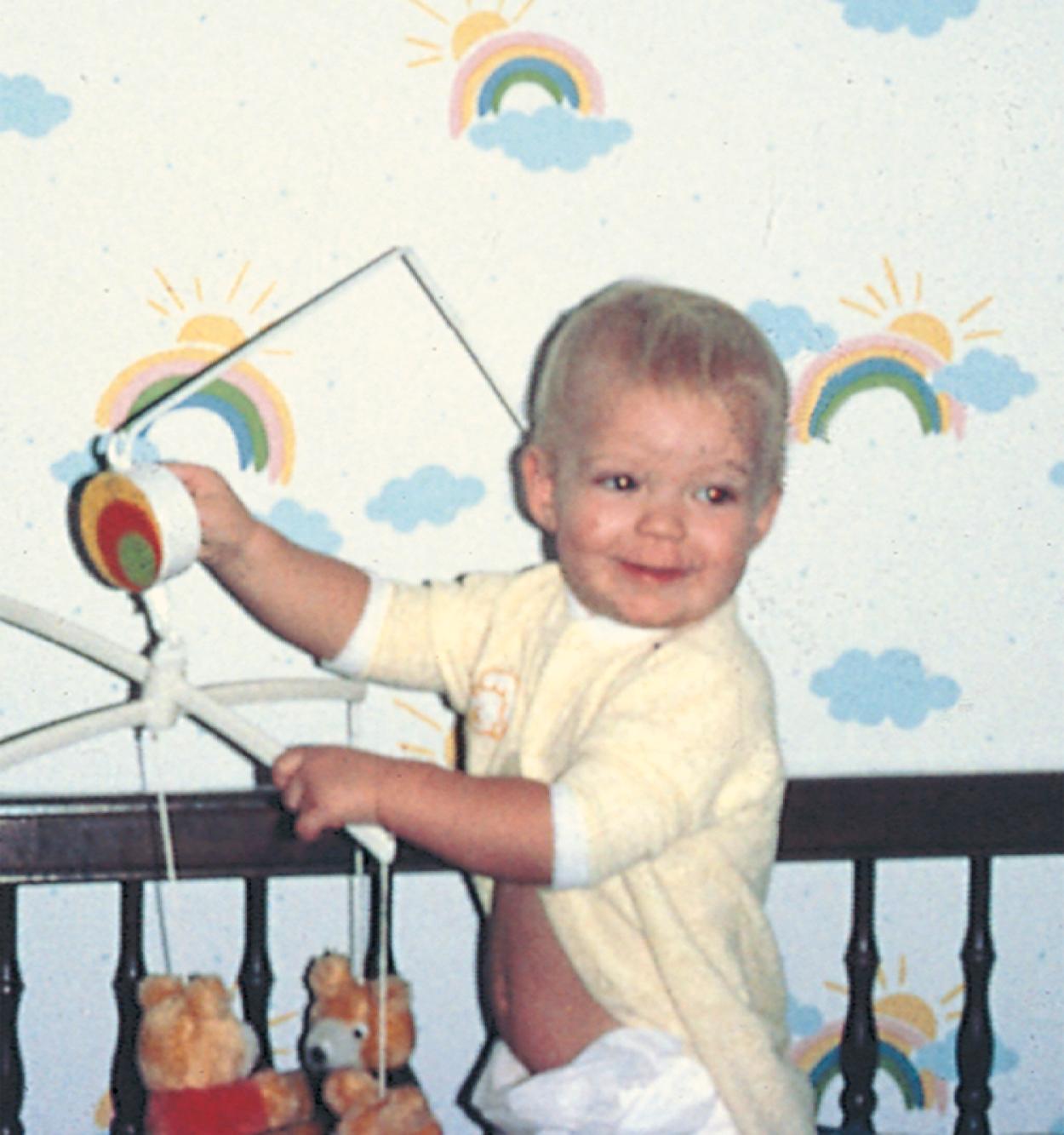 Fig. 3.25, Mature means/end reasoning. A 15-month-old child turns the key of the music box atop the mobile to make it play. The child’s understanding has advanced beyond that of direct causality, such as pulling a toy to bring it closer.