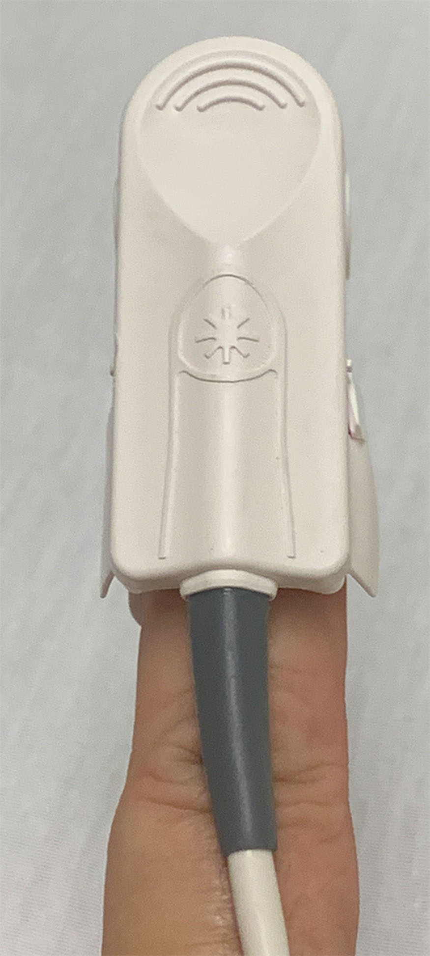 Fig. 2.8, Proper placement of the pulse oximeter sensor device on the patient’s index finger.