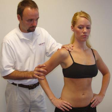 FIG. 50.4, The anterior slide test to help identify superior labral pathology. The patient’s hands are placed on the hips with the thumbs positioned posteriorly. The examiner stands behind the patient and places one hand on the superior shoulder and the other hand on the patient’s elbow. The examiner places a slightly anterior and superior force on the shoulder to load the biceps anchor. A positive test is indicated by pain in the anterior shoulder or a palpable click in the same region.