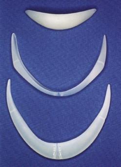 FIGURE 26.5, Silastic implants. From top to bottom: central implant; Mittelman Prejowl implant; Mittelman Prejowl Chin implant.