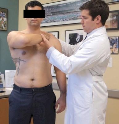 Fig. 8A.6, Photograph of bear hug test being performed.