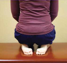 Fig. 108.2, Full knee flexion can be assessed by asking the patient to sit on his or her heels. If knee flexion is lacking in one knee, the patient shows a lateral pelvic tilt away from the involved knee.