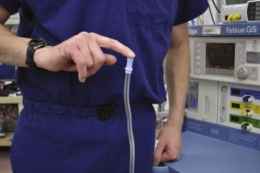 Fig. 25.3, Checking the negative pressure of the suction. The force of the suction should be adequate if this maneuver can be performed.