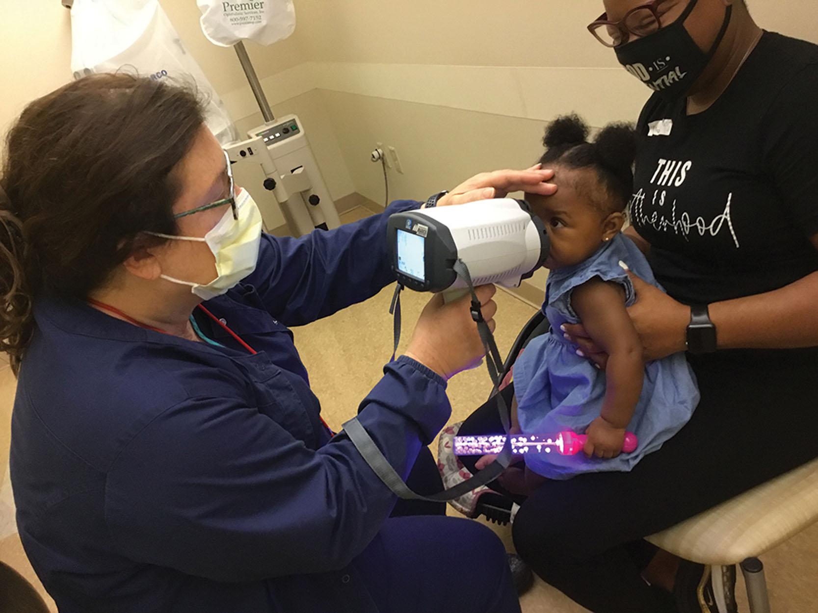 Fig. 6.3, Hand-held autorefraction can be successfully performed on cooperative children even under 1 year of age.