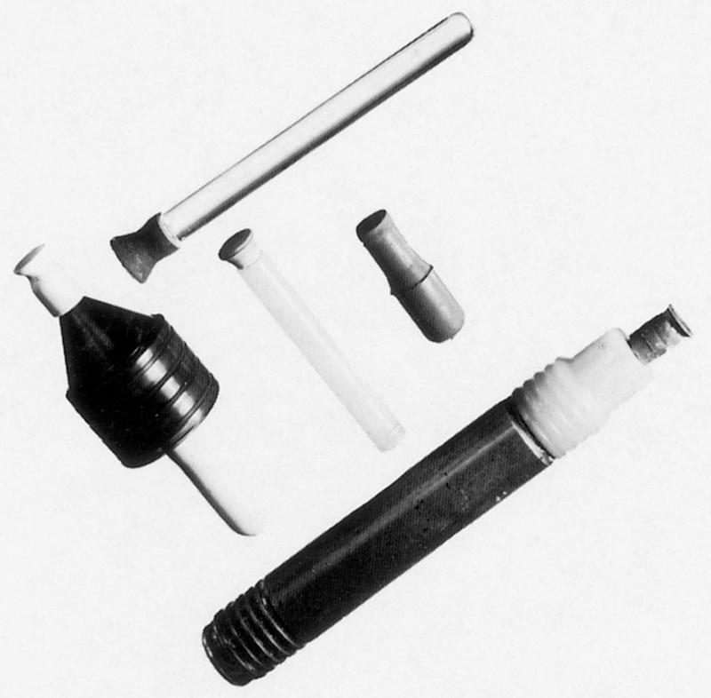 Fig. 33.2, Corneal lens holders. (a) Corneal lens suction holder cup mounted on a Perspex handle; (b) spinner (Madden & Layman Ltd.); (c) corneal lens suction holder cup mounted on a nylon handle; (d) modified scleral lens suction holder; (e) spinner.