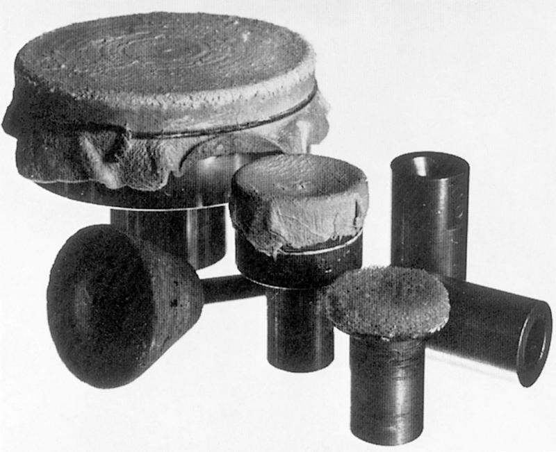 Fig. 33.5, Left to right: (rear) large polishing drum; (centre) carborundum tool for reduction of total diameter, small polishing drum and conlish tools; (front) flat plate sponge chuck.