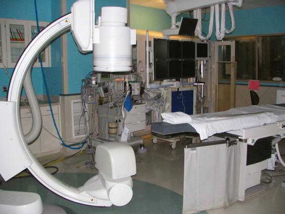 Fig. 75.1, A stationary C-arm fluoroscopic x-ray unit with a 15-inch image intensifier assembly.