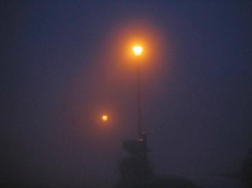 Fig. 75.14, Those same street lamps at night but with fog.