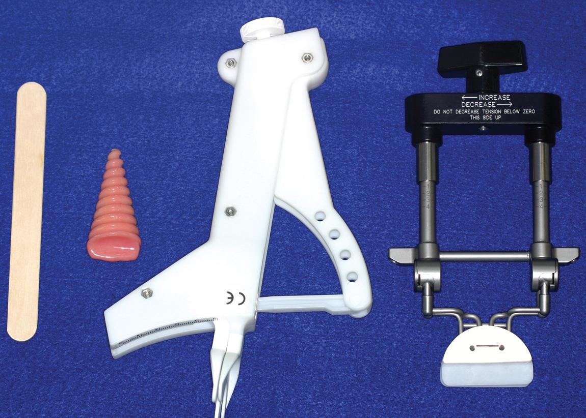 Figure 18.2, Devices for prevention of trismus. Left to right: tongue blades taped together in a stack, an acrylic resin “corkscrew,” a Therabite, and a Dynasplint.