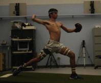 Fig. 32.1, Side view of a pitcher at the point of maximal shoulder and elbow stress. This point is defined as early acceleration with the shoulder near its point of maximal external rotation.