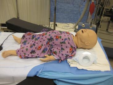 FIGURE 53.2, An infant human patient simulator (Laerdal SimBaby, Laerdal Medical, Stavanger, Norway) exhibits standard vital signs, variable airway features (tongue swelling, laryngospasm), breath sounds (retraction, wheezing), cardiovascular features (palpable pulses, heart sounds), and others (abdominal sounds, bulging fontanel).