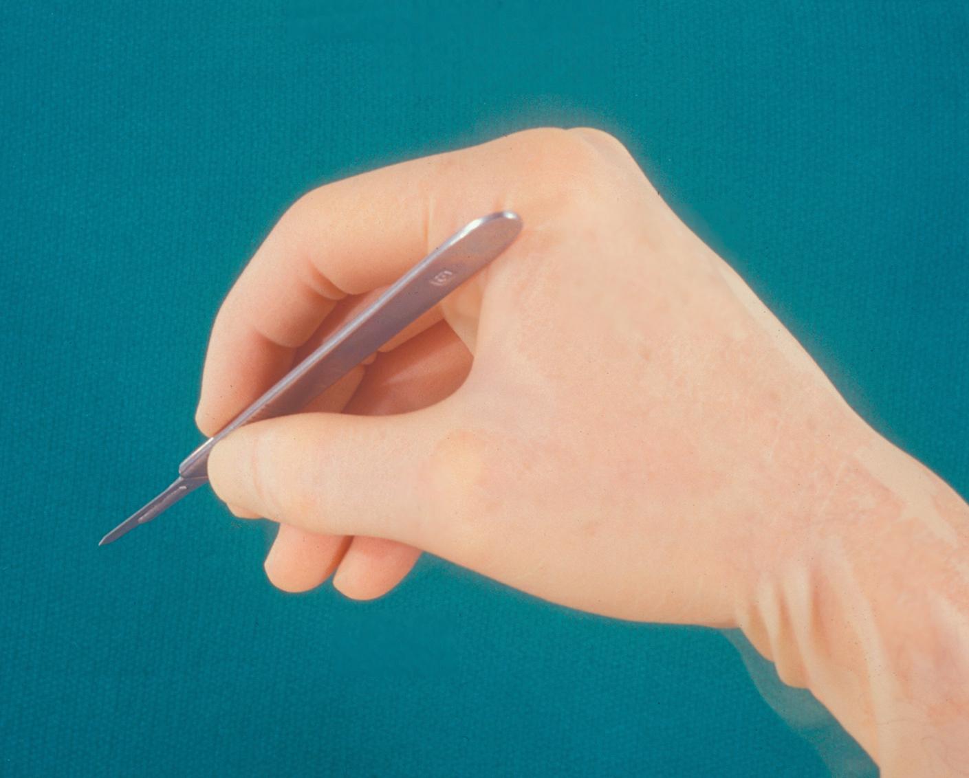 Figure 1.2, Holding the scalpel with the pencil grip. Note that the hand is in the functional position in slight flexion.