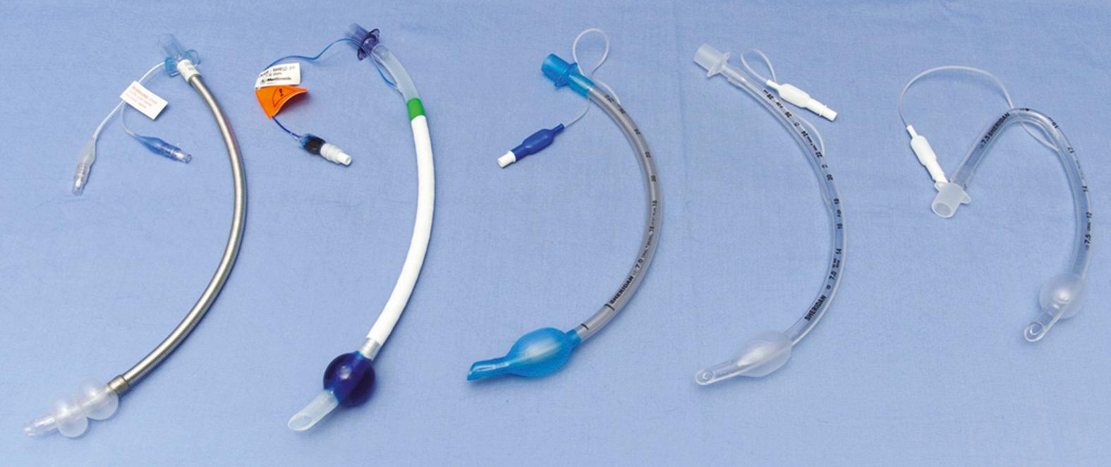 Fig. 97.8, Left to right, Mallinckrodt laser-safe tube (note the two distal balloons, one for air, one for saline); Laser-Guard laser-safe tube (note the methylene blue in the distal balloon); wire spiral tube (compression resistant); standard tube; and down right-angled endotracheal tube. The latter three tubes are polyvinylchloride-based endotracheal tubes.