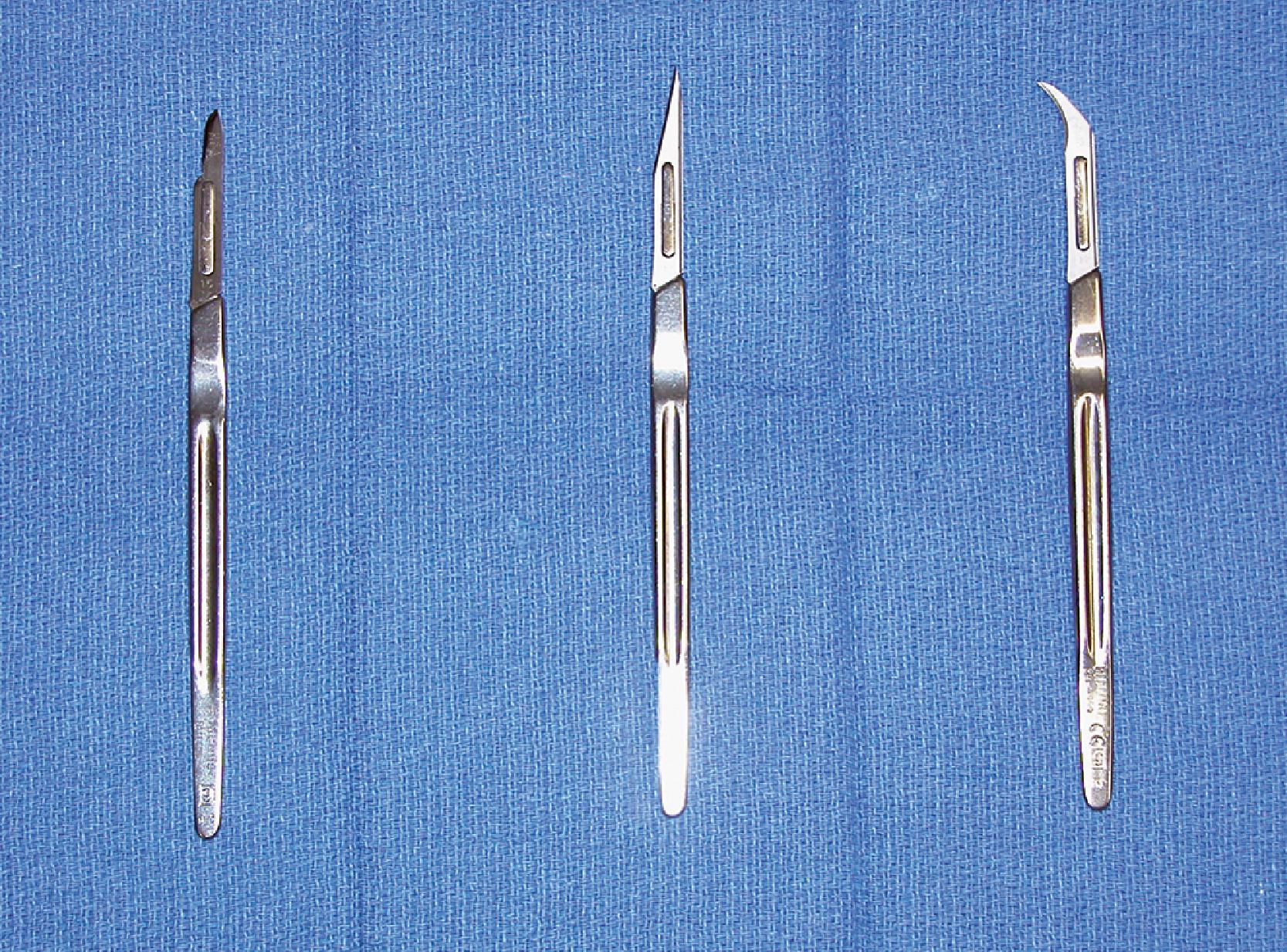 FIG. 4.1, The diversity of available surgical blades is demonstrated by the No. 15, No. 11, and No. 12 blades.