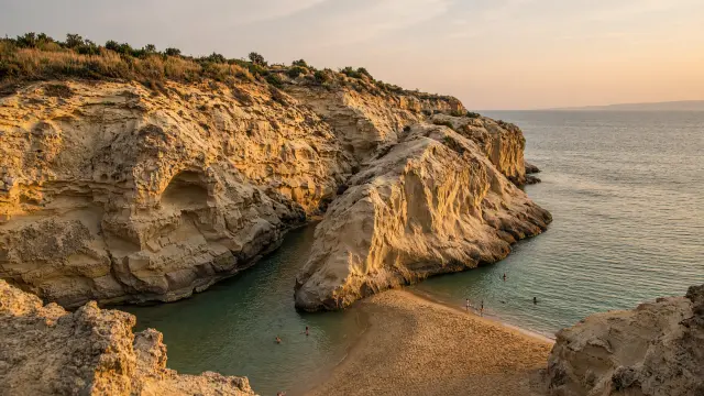 Uitgesleten zandsteenkliffen met een smalle geul van groenblauw water bij Sidari op Corfu
