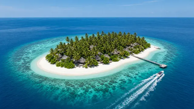 Resorteiland met palmbomen, een steiger en een vertrekkende speedboot in een turquoise lagune