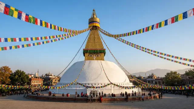 Boudhanath-stoepa in Kathmandu met gebedsvlaggen en kleine pelgrims rond de voet