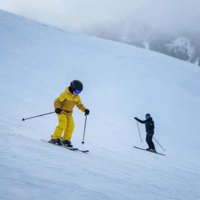 Familieskigebied Maiskogel met kinderen op brede oefenpistes, skipas-gondel en bergrestaurant met uitzicht op de Oostenrijkse Alpen