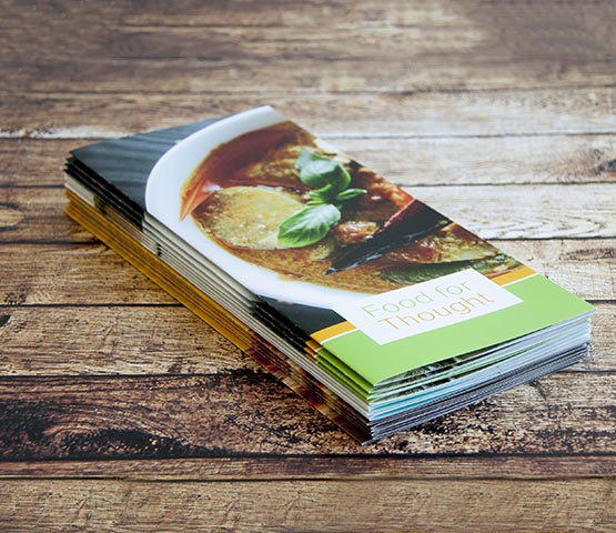 A stack of brochures for a culinary workshop.