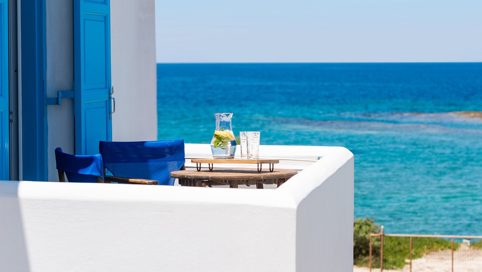 Domus Litus Superior Studio balcony with sea view and little table with lemonade on it.