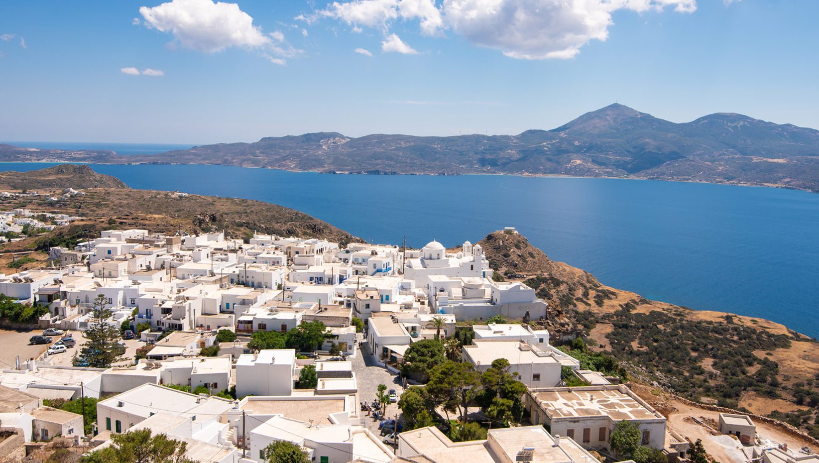 Milos island drone view. Traditional white Cycladic houses. and sea view.