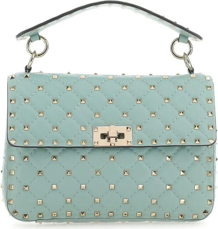 Handbag realized in lamb nappa leather enriched by metal studs on the entire surface.