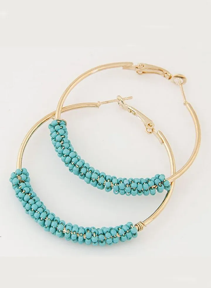 Women's Earrings Decorated With Light Blue Beads