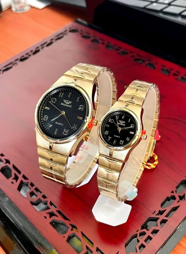 couple watches for men and women in gold and black, water resistant, with a box
