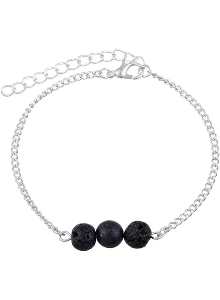 An anklet of a metallic mixture and a black volcanic stone