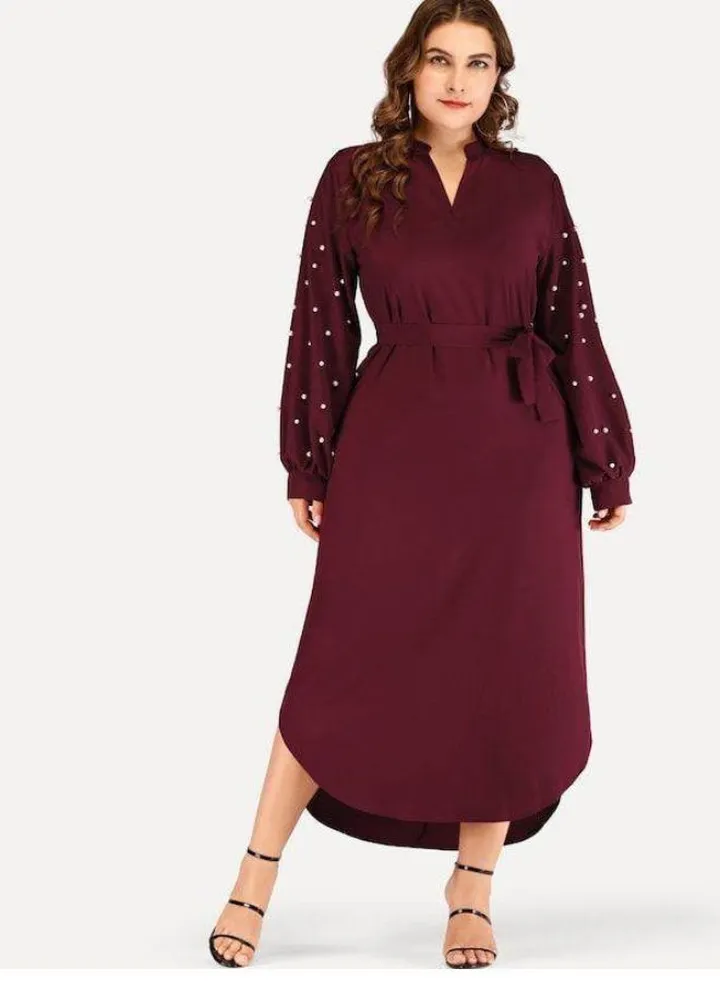 Women's dress decorated with artificial pearl beads