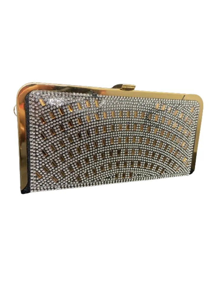 A luxurious women's bracelet bag, gold and black, decorated with a golden metal arm