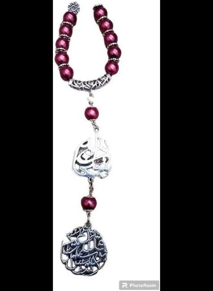 Car pendant made of red beads with religious silver pendants
