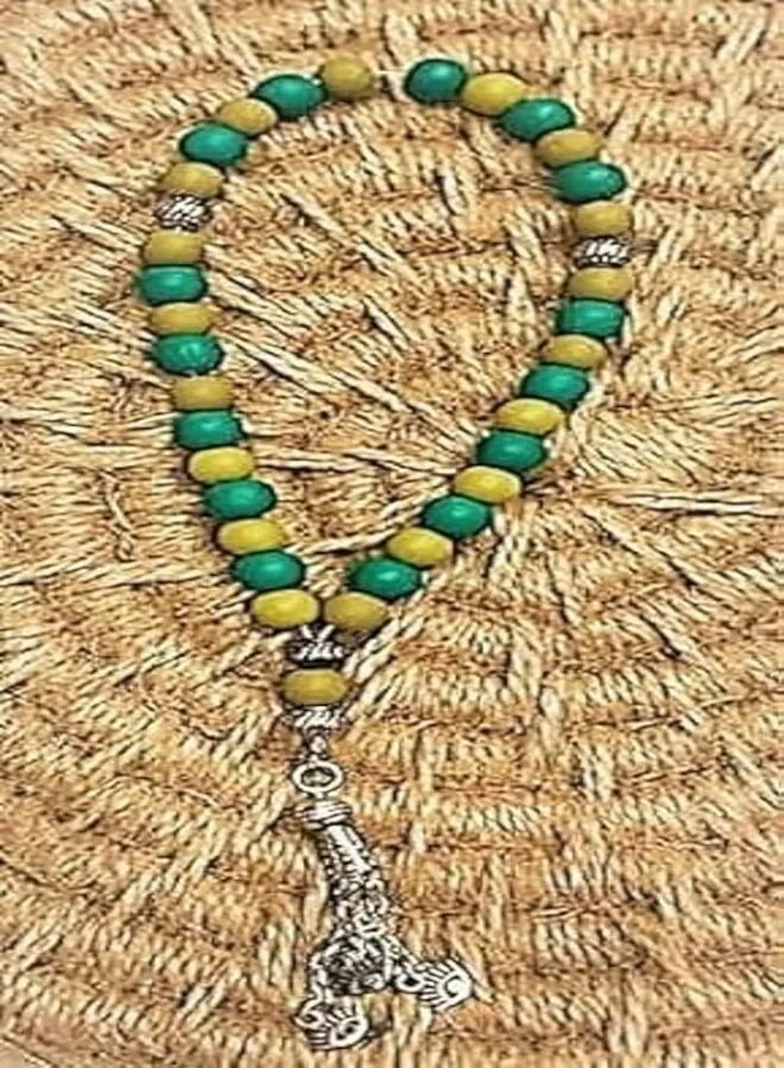Rosary made of 33 beads green*yellow with a silver pendant