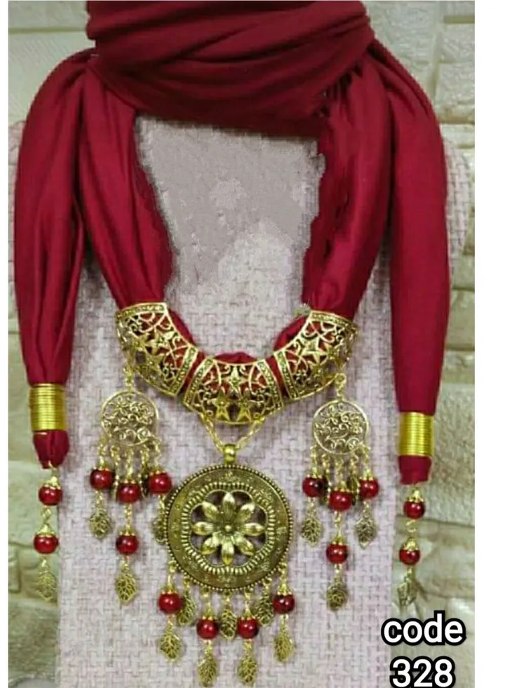 A scarf necklace made of lycra cotton with pendants of various shapes and sizes of golden nickel