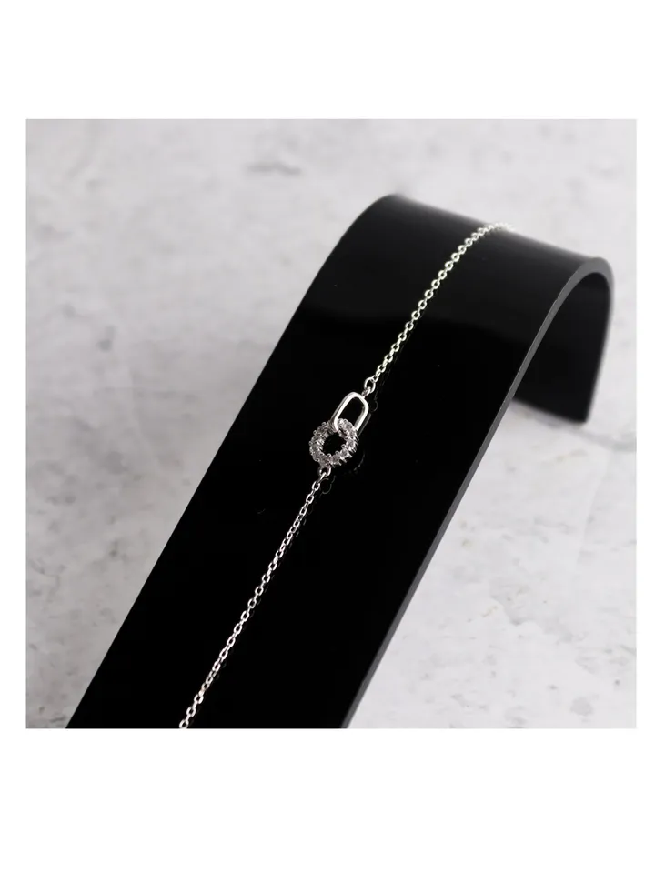 A unique silver women's bracelet with a circular pendant design