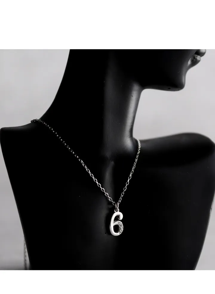 A unique silver women's chain with a pendant design containing the number 6