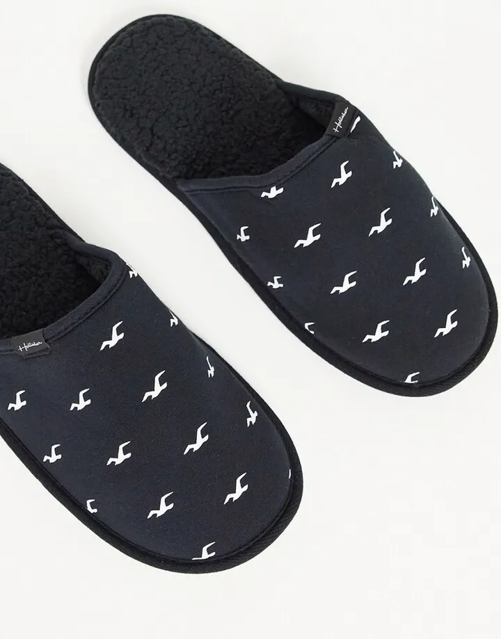 Hollister slippers in black with all over logo