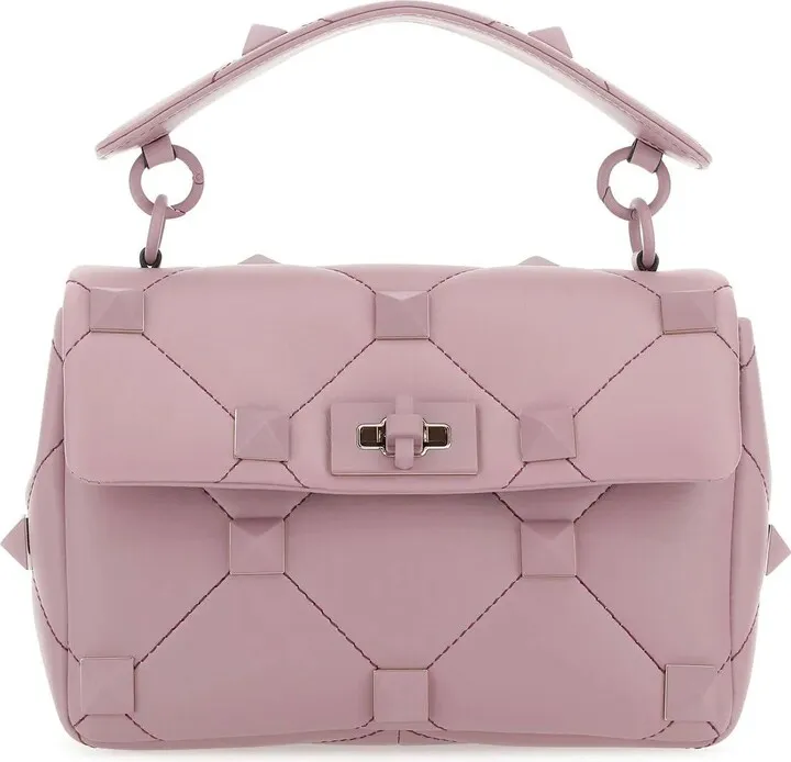 Handbag realized in quilted lamb nappa leather enriched by metal studs on the entire surface.