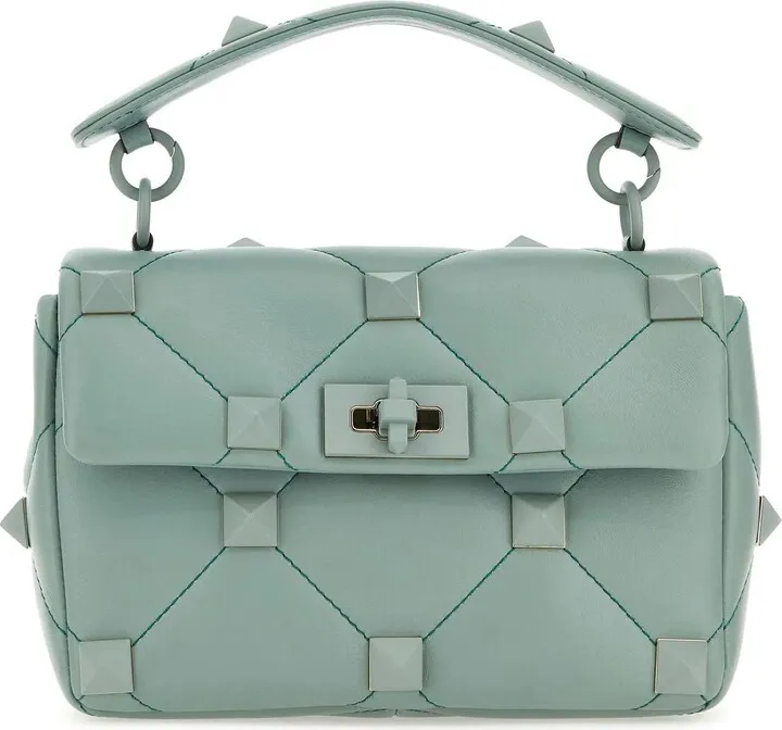 Handbag realized in quilted lamb nappa leather enriched by maxi enameled metal studs on the entire surface.