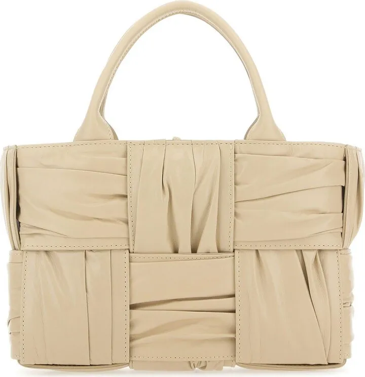 Handbag realized in pleated calf leather characterized by iconic Intrecciato motif on the entire surface.