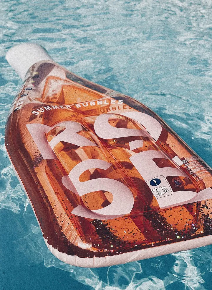 Luxe Rose Bottle Inflatable Pool Float