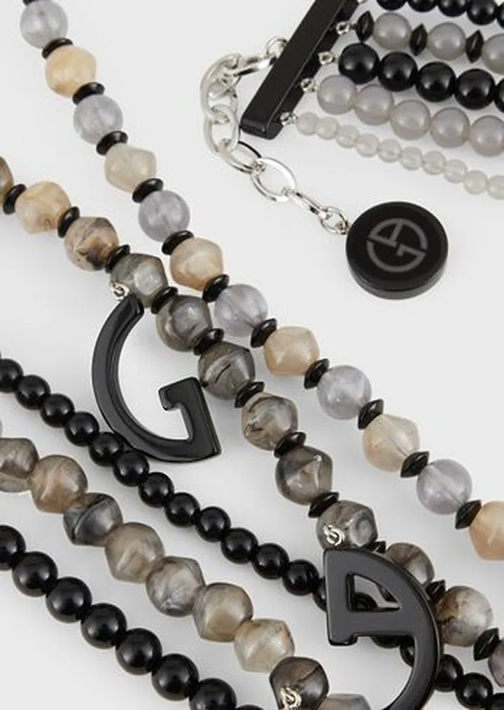 Multistrand necklace with resin spheres and logo pendants