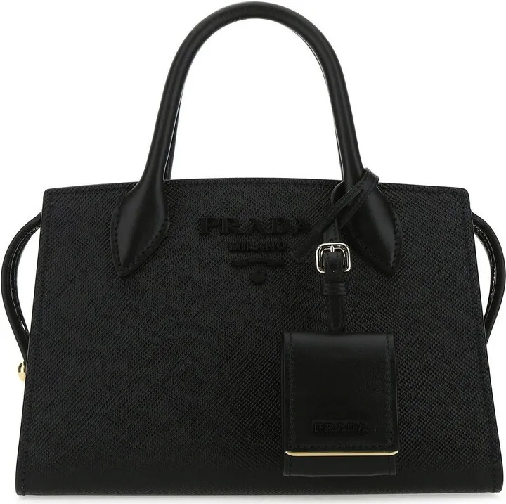 Handbag realized in Saffiano leather enriched by tonal metal lettering logo at the front and detachable tonal leather accessory.